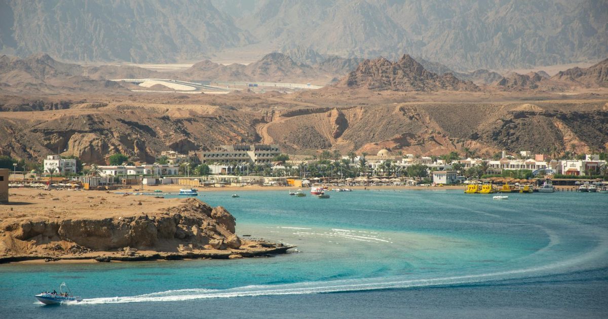 boat anchored near Hurghada beach during island hopping day trips from Hurghada