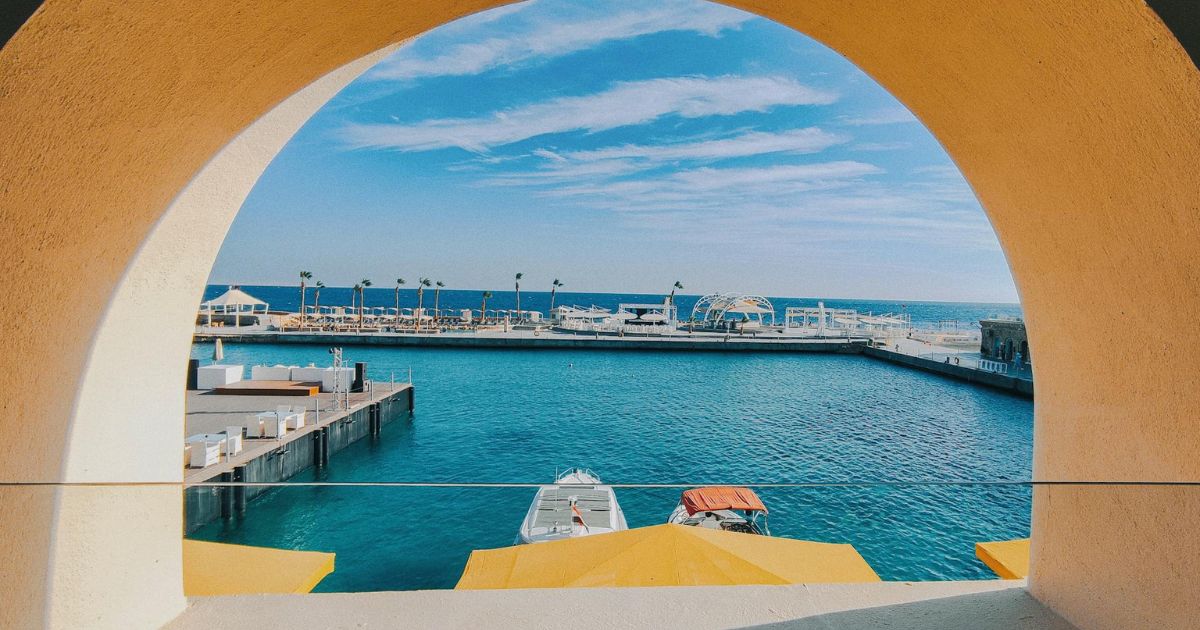 day trips from Hurghada showing calm Red Sea beach with turquoise water and soft sand